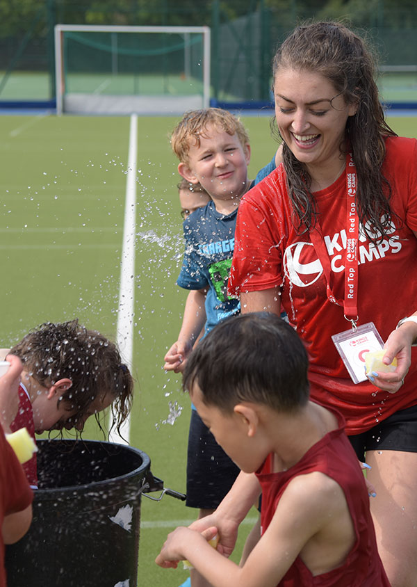 a red top and children enjoying wet wednesdays activities