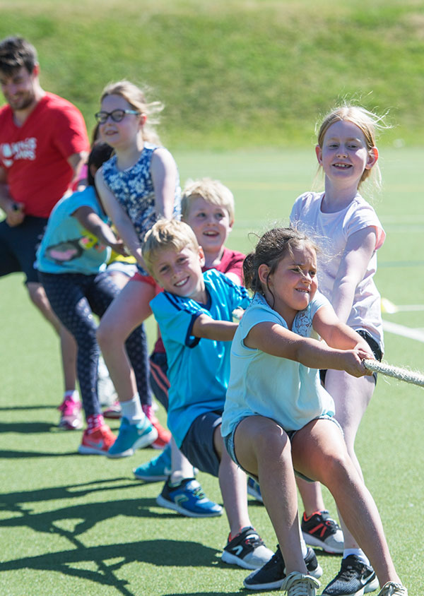 a group of children playing tug of war