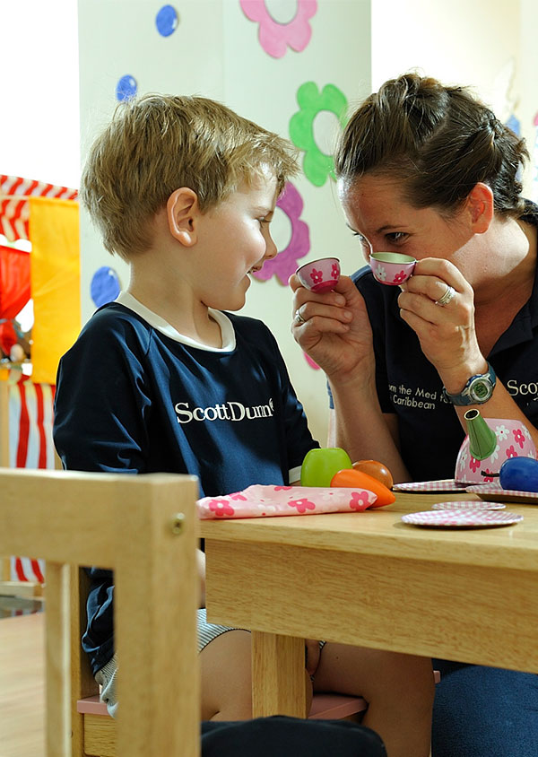 a staff member playing with a young boy