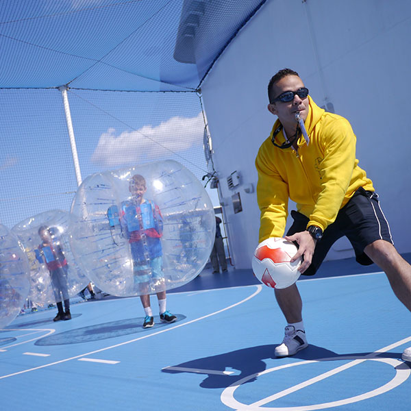 recruitment_002 a sports coach with whistle in his mouth and ball in his hand