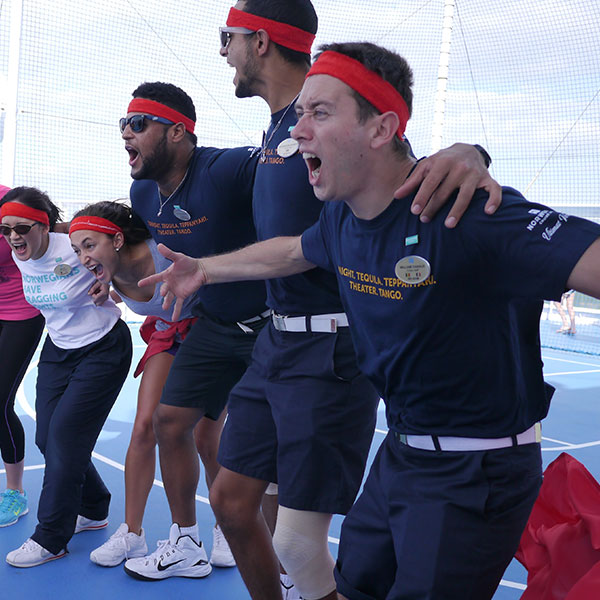 group of people linking arms whilst cheering