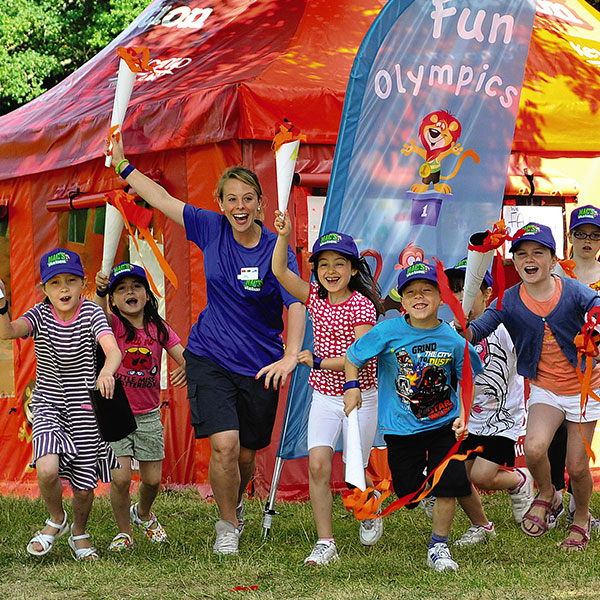 staff member and children smiling and playing