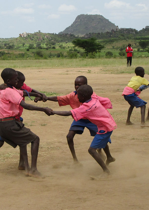 children holding hands in a circle playing