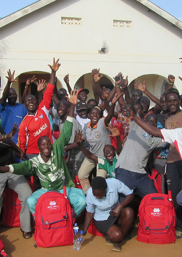 group of people in Botswana cheering with their hands in the air