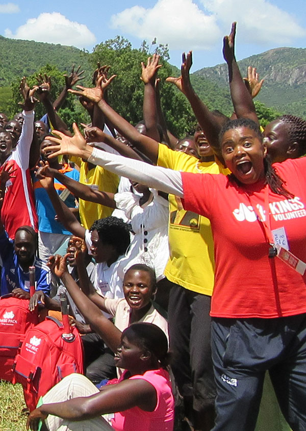 a group of people in botswana smiling with their hands in the air