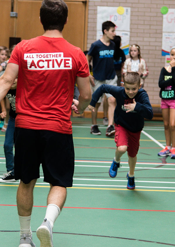 a child runing towards a red top coach