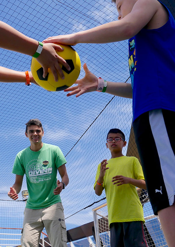 two people passing a football to one another