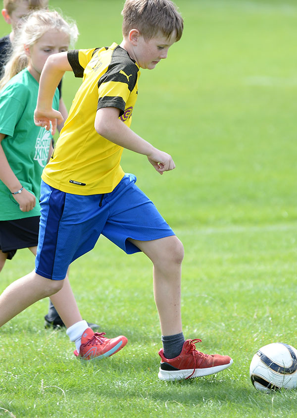 camps_013 a child dribbling a football