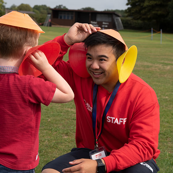 camps_015 a red top and a child playing and smiling