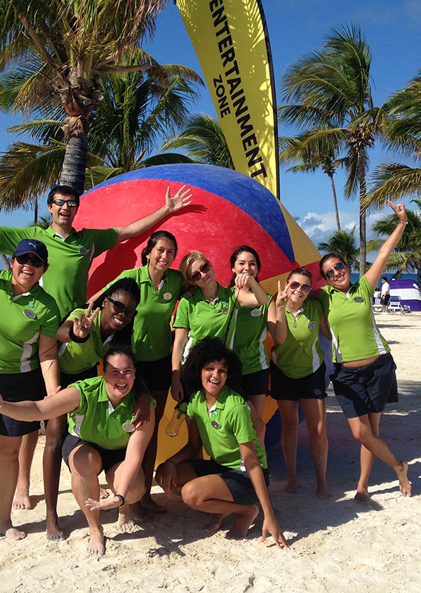 a group of staff on a beach