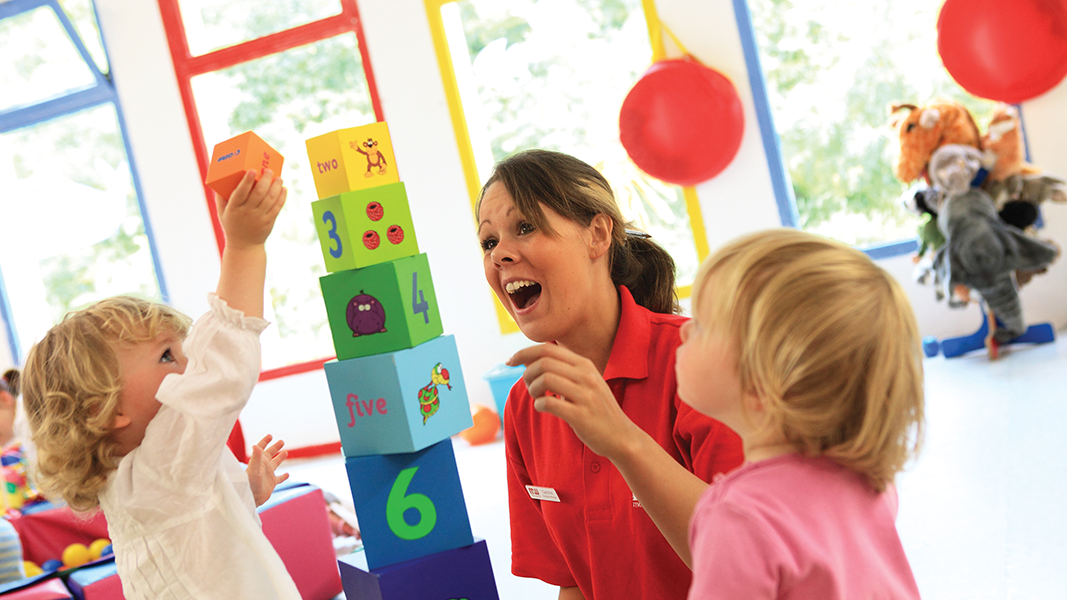 resort staff and children playing with building blocks