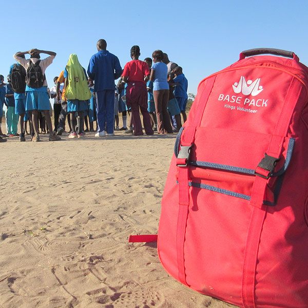 a base pack on the sand with a group of people in the background