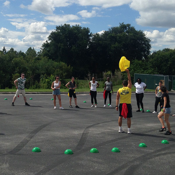 a sports coach delivering a sports session outdoors