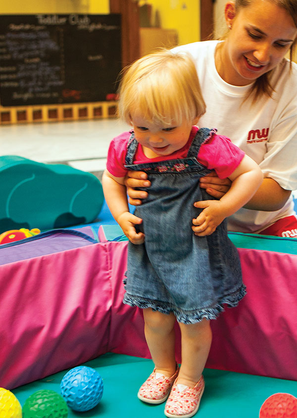 a small child in a ball pit on a holiday resort