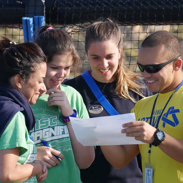 kings active leaders with some pupils gathered round smiling