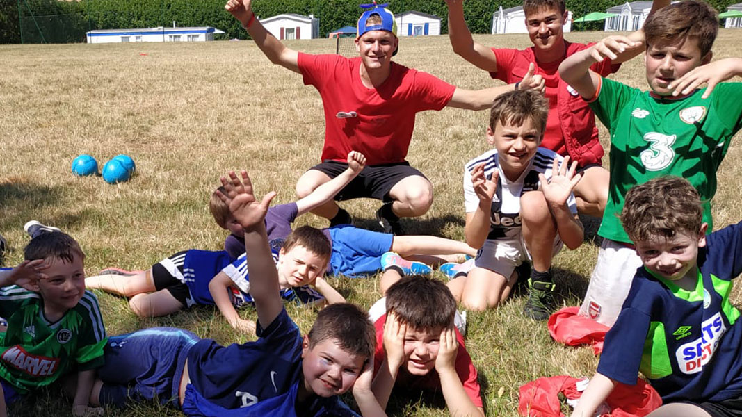 a group of children on the grass enjoying themselves